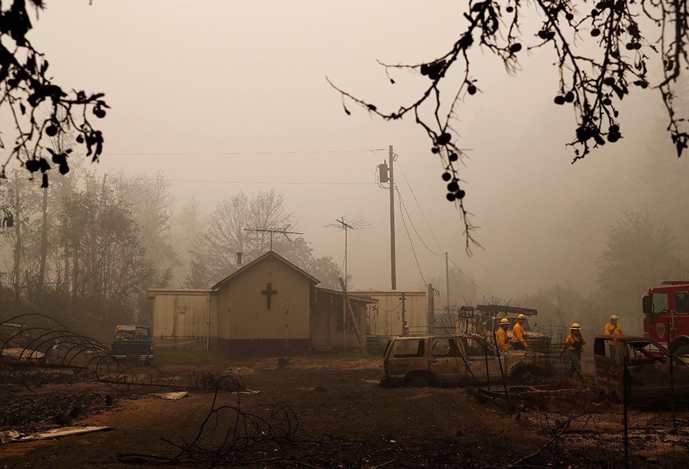 Firefighters in Detroit, Oregon, assess wildfire damage to a church Sept. 14, 2020, in the aftermath of the Beachie Creek Fire. (CNS/Reuters/Shannon Stapleton)