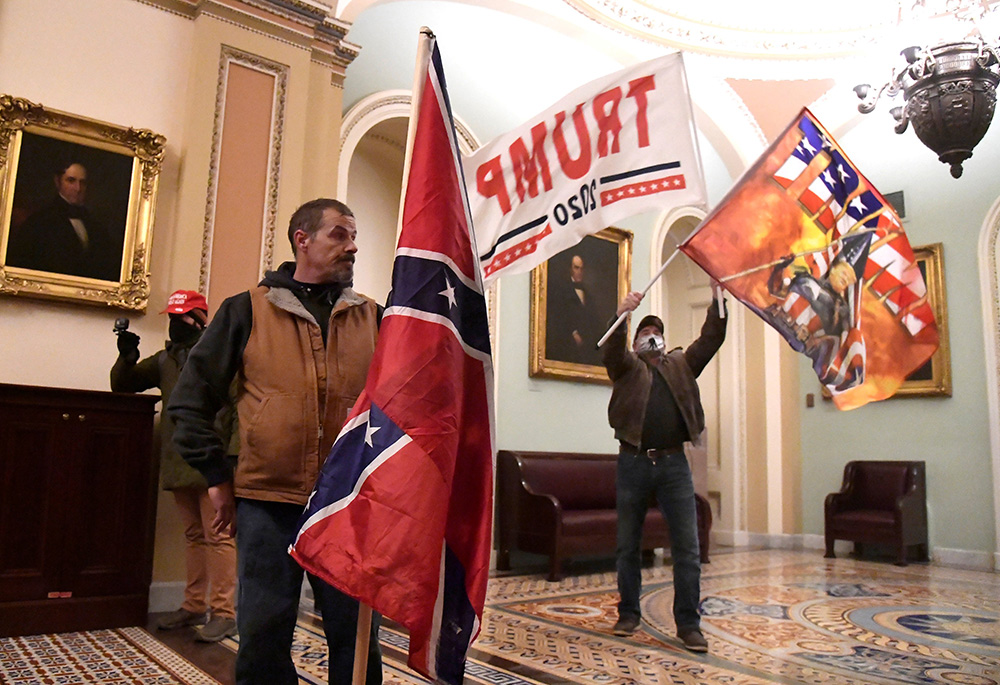 Supporters of President Donald Trump demonstrate on the second floor of the U.S. Capitol building in Washington near the entrance to the Senate after breaching security defenses Jan. 6. (CNS/Reuters/Mike Theiler)