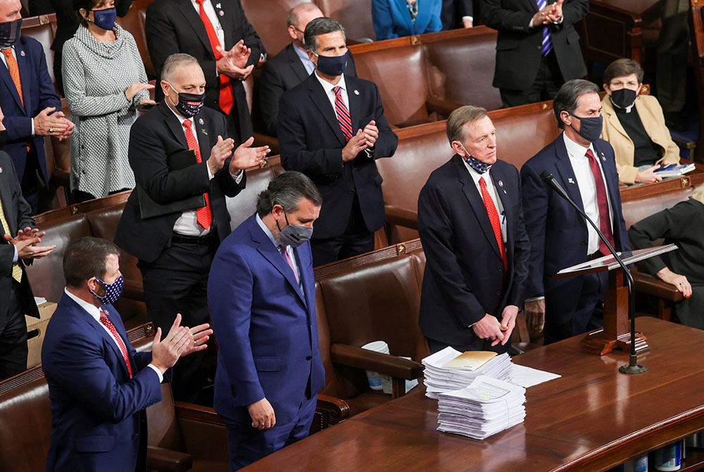 Rep. Paul Gosar, R-Ariz., right, and Sen. Ted Cruz, R-Texas, receive applause from Republicans inside the House Chamber on Capitol Hill Jan. 6 in Washington, for objecting to Arizona's votes during a joint session to certify the 2020 presidential election