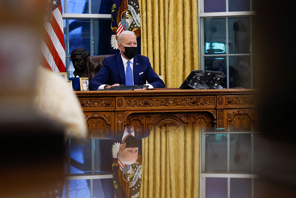 President Joe Biden signs executive orders at the White House Feb. 2 in Washington. (CNS/Tom Brenner, Reuters) President Joe Biden signs executive orders at the White House Feb. 2 in Washington. (CNS/Tom Brenner, Reuters)