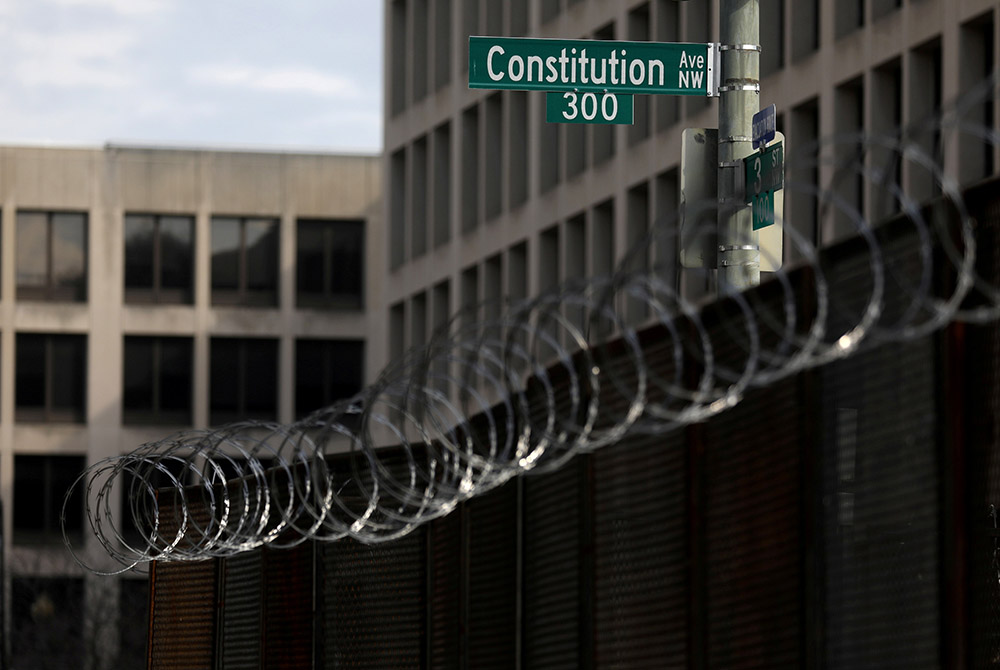 Fencing topped with razor wire surrounds buildings on Capitol Hill in Washington Feb. 9, the first day of the second impeachment trial of former President Donald Trump. (CNS/Leah Millis, Reuters) Fencing topped with razor wire surrounds buildings on Capitol Hill in Washington Feb. 9, the first day of the second impeachment trial of former President Donald Trump. (CNS/Leah Millis, Reuters)