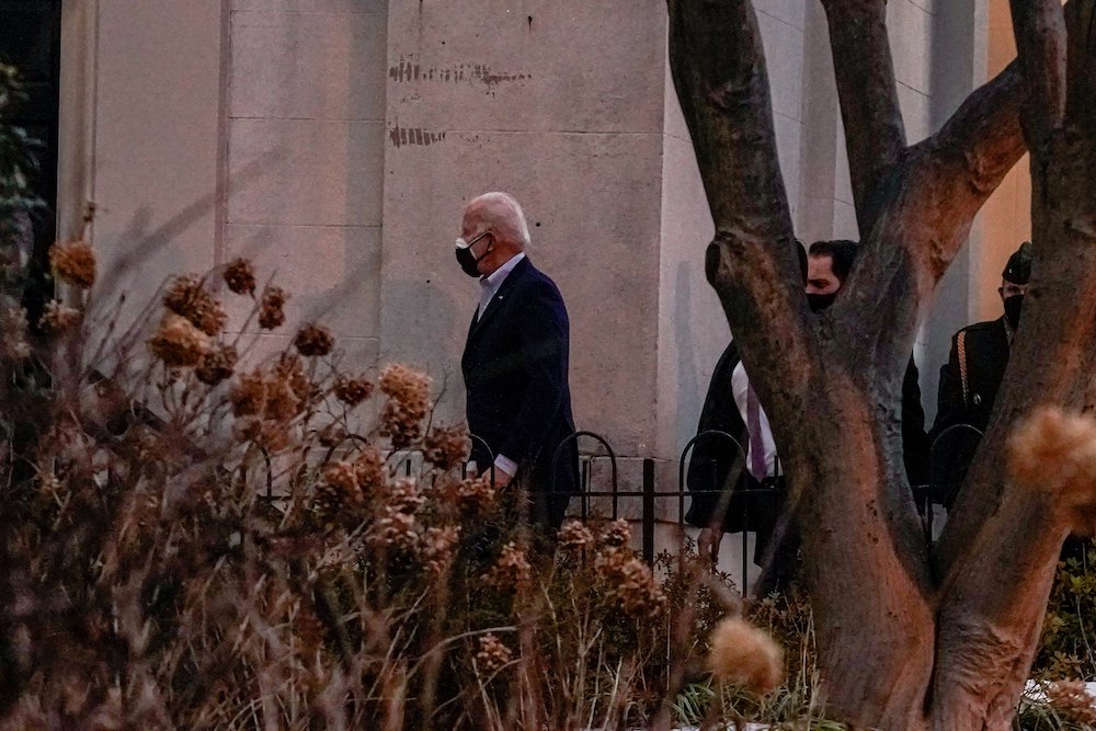 President Joe Biden walks into Holy Trinity Catholic Church to attend Mass Feb. 20 in Washington. (CNS/Ken Cedeno, Reuters)