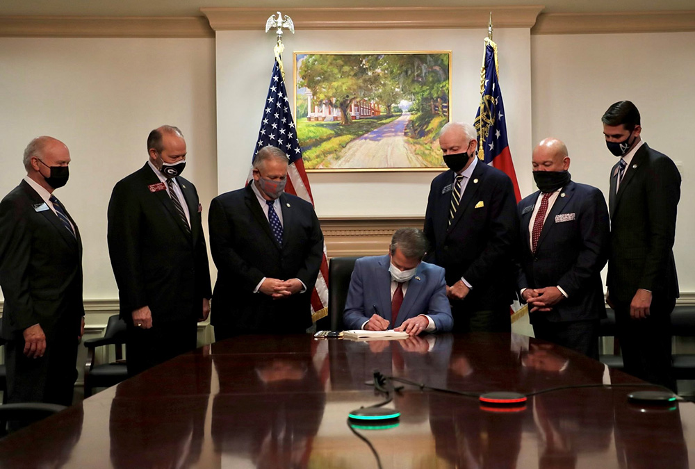 Georgia Gov. Brian Kemp signs the Election Integrity Act of 2021 in Atlanta March 25. (CNS/Gov. Brian Kemp, Twitter, Handout via Reuters)