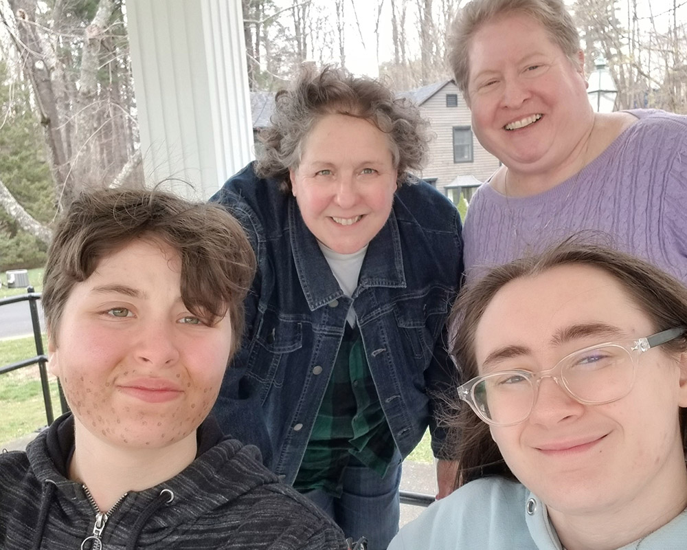 Marianne Duddy-Burke, top right, takes a family photo with her spouse Becky and their children Finn and Emily. The Catholic Church turned Marianne and Becky away from adopting children because "they knew we were a female couple." She and Becky eventually 