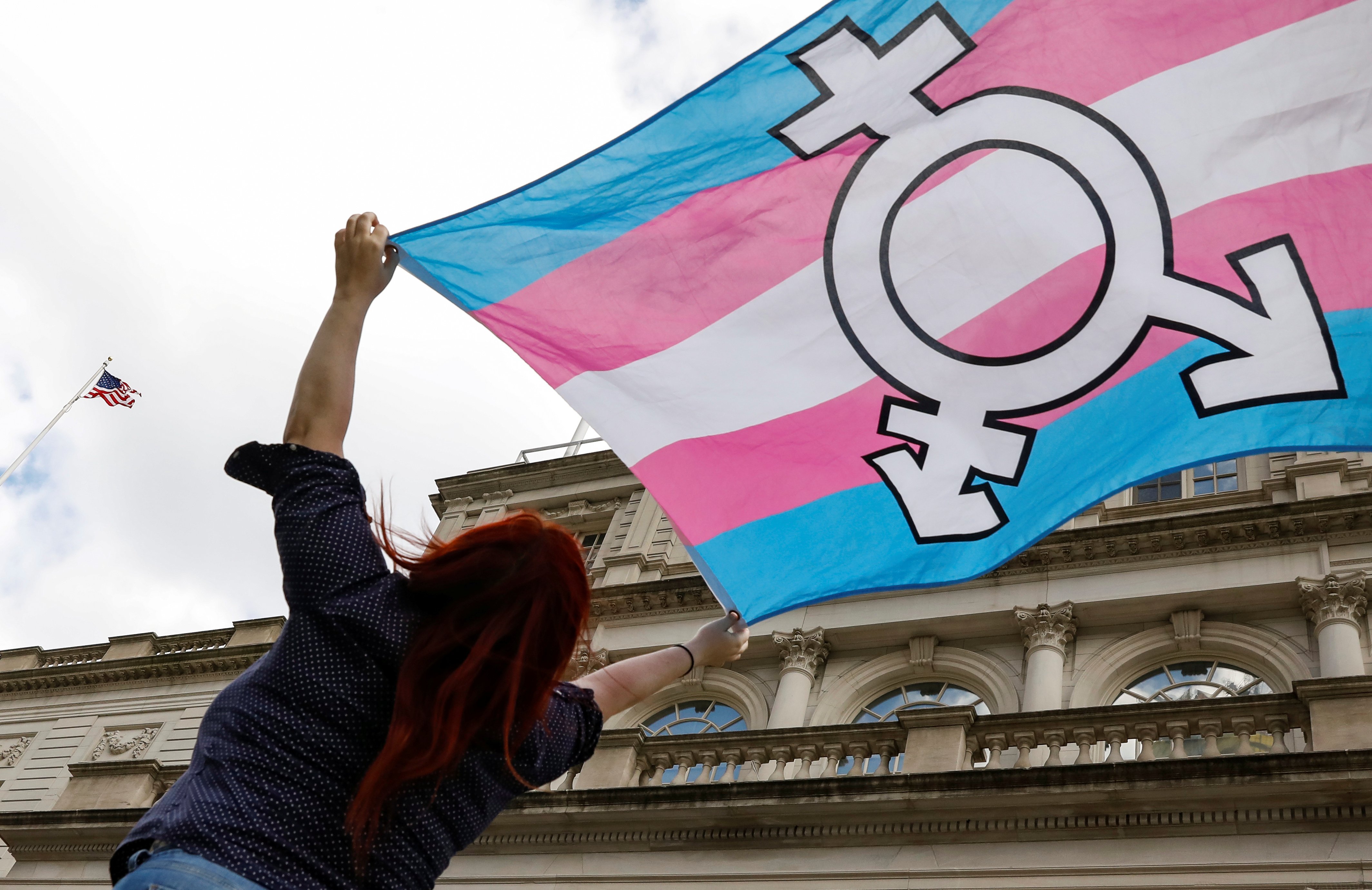 A person in New York City holds up a transgender flag Oct. 24, 2018. (CNS photo/Brendan McDermid, Reuters)