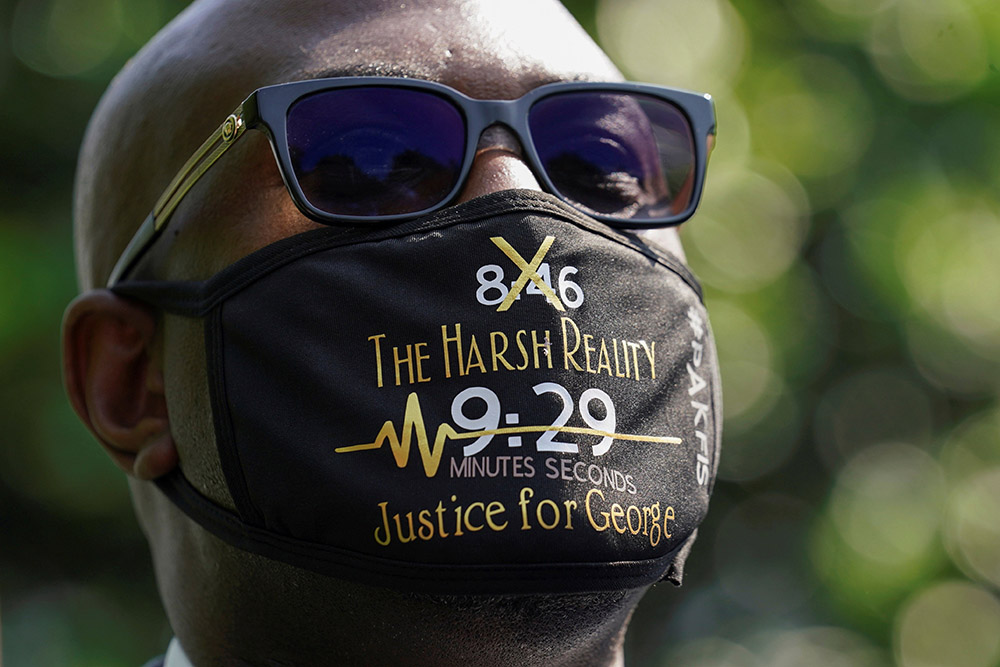 Philonise Floyd wears a face mask referencing his brother George's killing as he and other family members speak with reporters at the White House following their meeting with President Joe Biden in Washington May 25. (CNS/Reuters/Kevin Lamarque) Philonise Floyd wears a face mask referencing his brother George's killing as he and other family members speak with reporters at the White House following their meeting with President Joe Biden in Washington May 25. (CNS/Reuters/Kevin Lamarque)