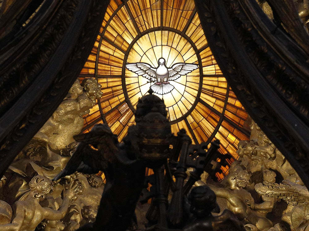 The Holy Spirit window is seen through the baldacchino in St. Peter's Basilica at the Vatican. (CNS/Paul Haring)