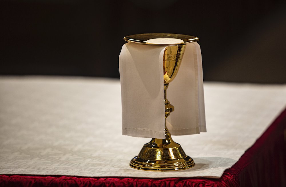 The Eucharist rests upon a paten on an altar in a cathedral. (CNS/Chaz Muth)