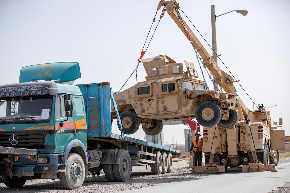 U.S. Army soldiers and contractors load a military vehicle for transport U.S. Army soldiers and contractors load a military vehicle for transport as U.S. forces prepare for withdrawal, in Kandahar, Afghanistan, July 13, 2020. (CNS/U.S. Army Sgt. Jeffery J. Harris handout vis Reuters)