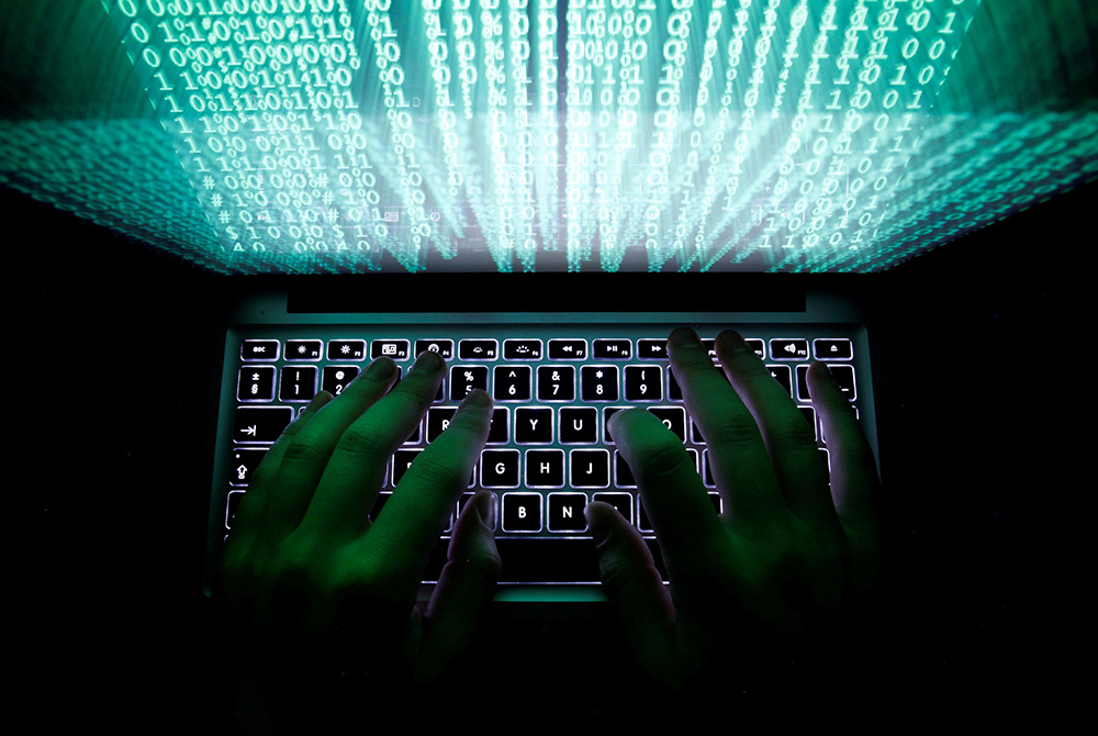 A man types on a computer keyboard in this illustration photo. (CNS/Reuters/Kacper Pempel)