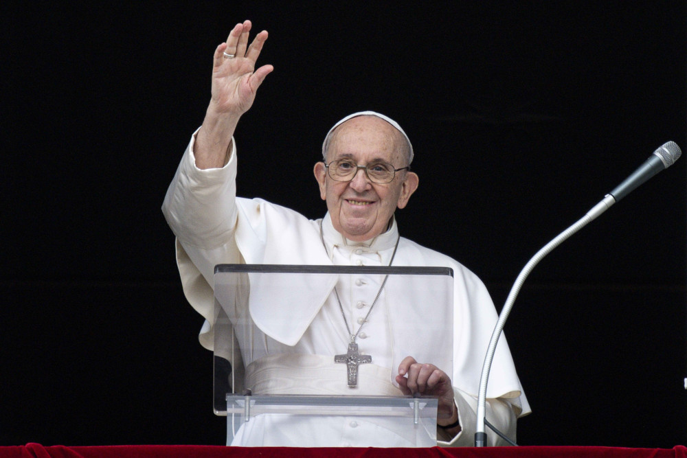 Pope Francis greets the crowd as he leads the Angelus from the window of his studio overlooking St. Peter's Square at the Vatican July 25. (CNS/Vatican Media)