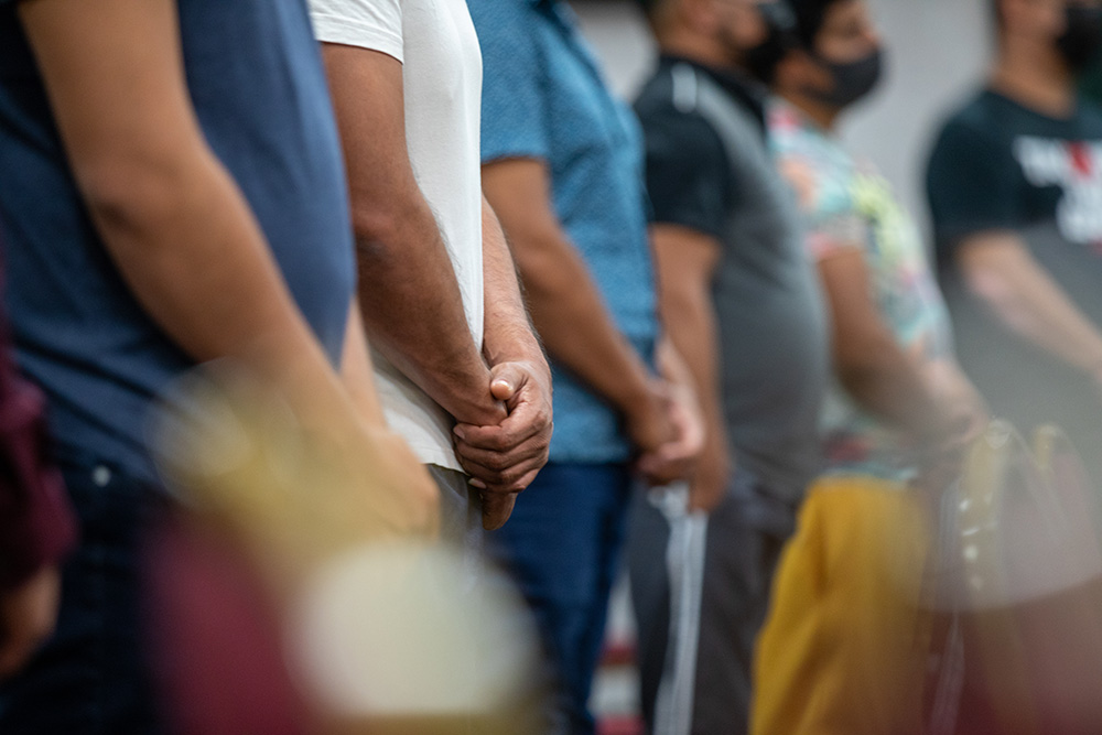 A group of farmworkers attend evening Mass celebrated by Bishop Joseph Tyson July 28 at the Fairbridge Hotel in Yakima, Washington, where they live during cherry-picking season. (Courtesy of Catholic Extension)