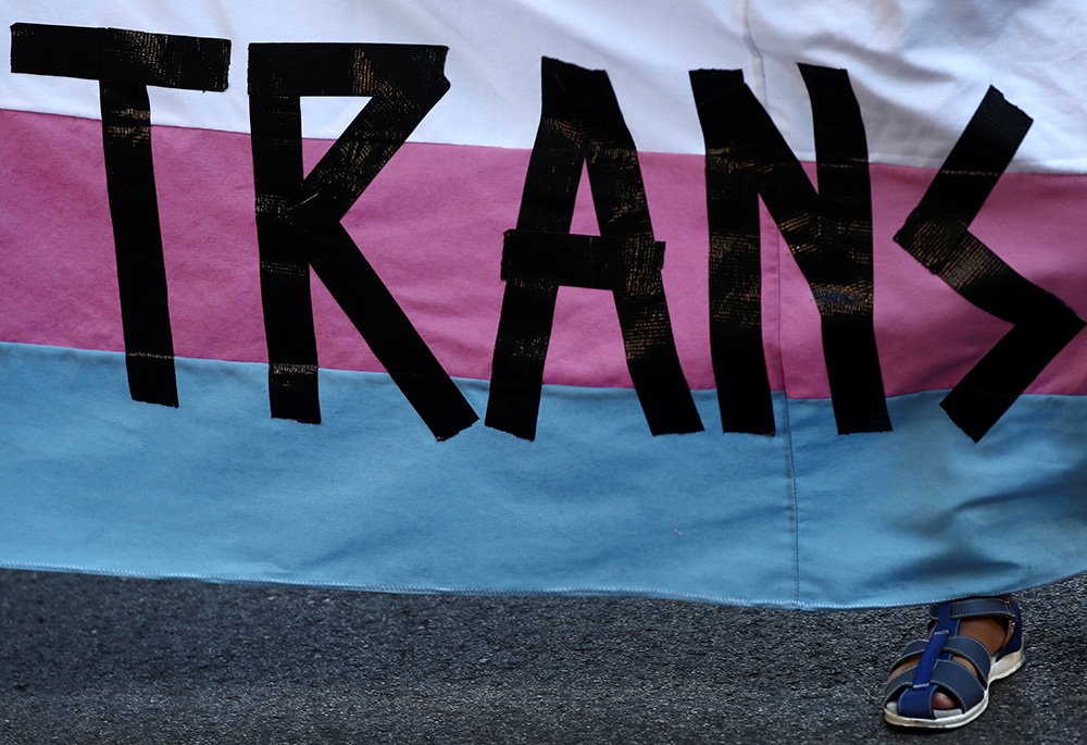 A person holds a "Trans" banner in this illustration photo. (CNS/Reuters/Sergio Perez)