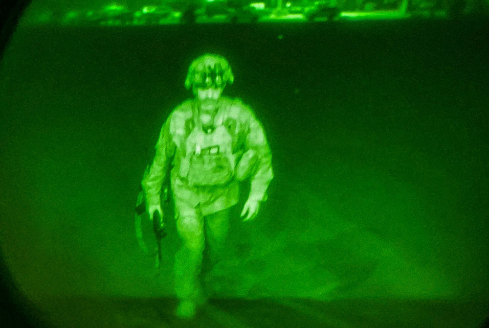 Last US service member to leaves Kabul, Afghanistan, Aug. 30 U.S. Army Maj. Gen. Chris Donahue, commander of the 82nd Airborne Division, steps on board a transport plane as the last U.S. service member to leave Kabul, Afghanistan, Aug. 30, in a photo taken via night vision optics. (CNS/XVIII Airborne Corps/Reuters)