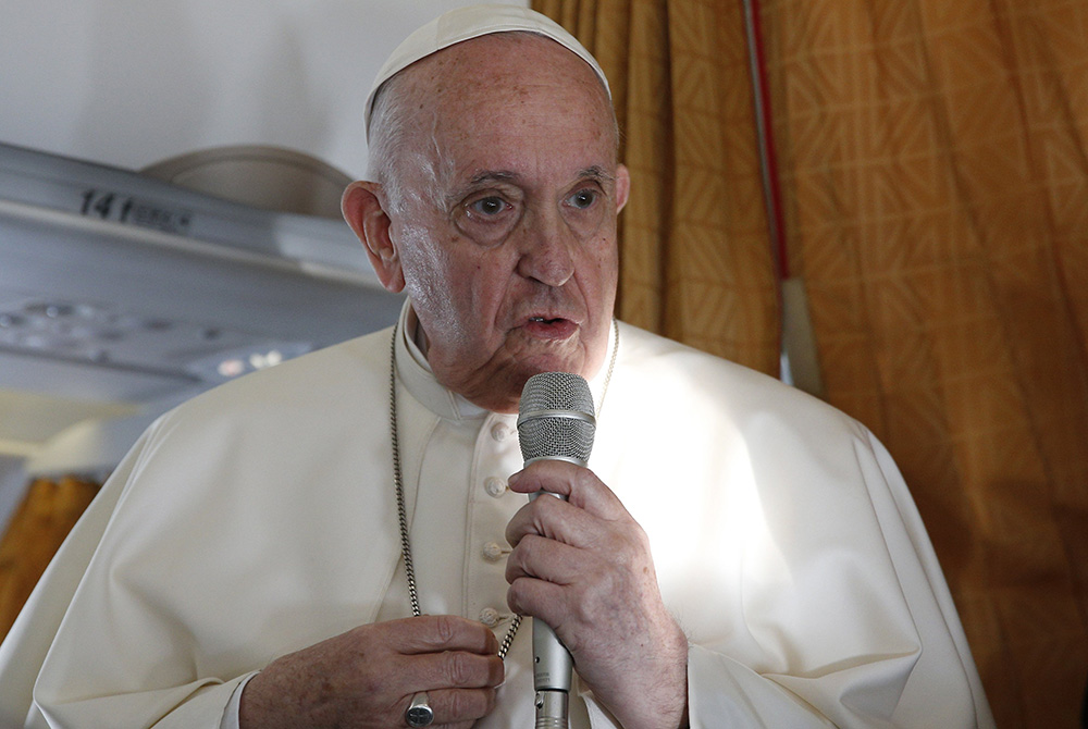 Pope Francis answers questions from journalists aboard his flight Sept. 15 from Bratislava, Slovakia, to Rome. (CNS/Paul Haring)