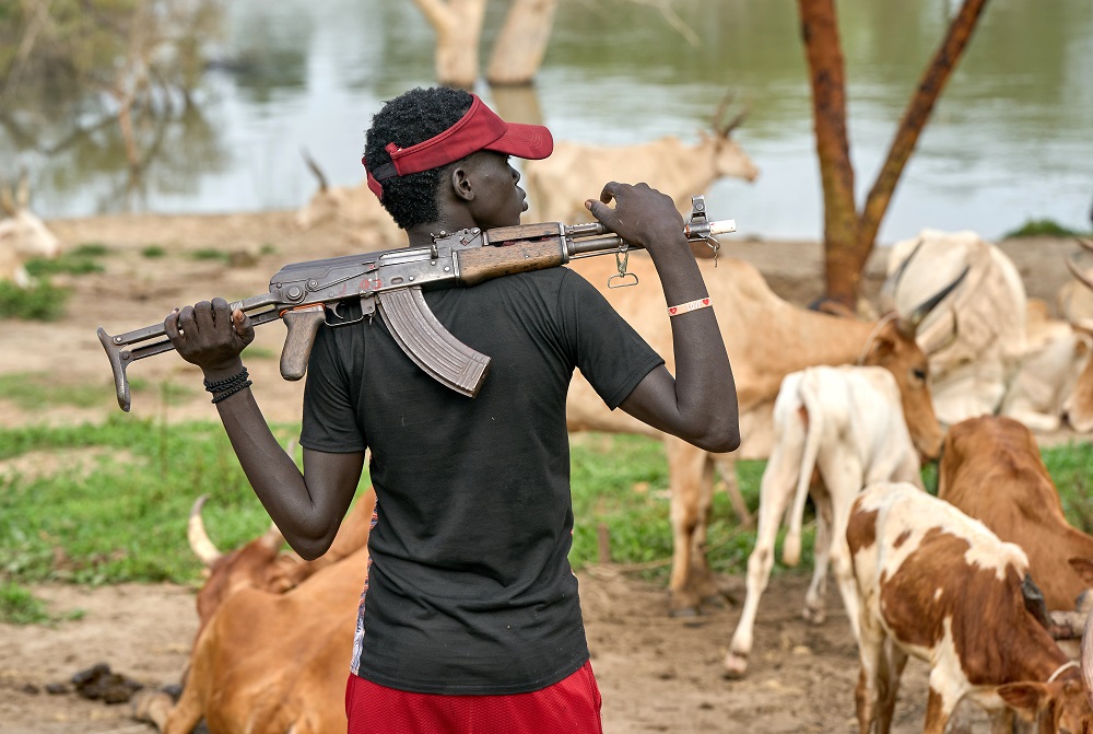 A cattle keeper holds an assault rifle Sept. 1 in Mogok, South Sudan.