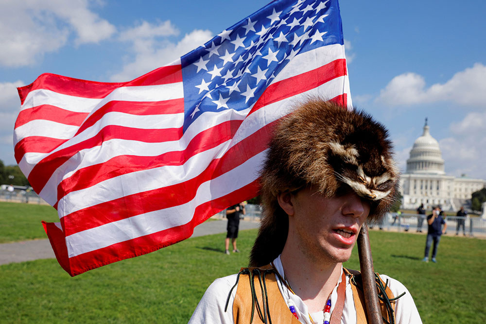 A man in Washington wearing a raccoon hat Sept. 18 talks about how he believes former President Donald Trump won the 2020 election but it was stolen from him through fraud.