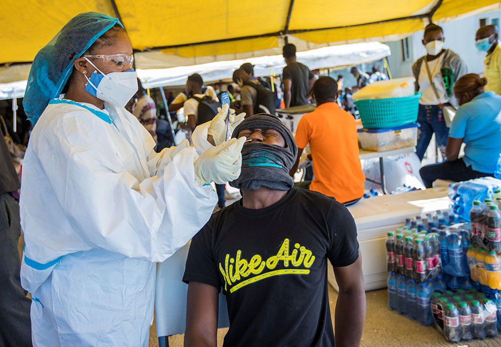 A Haitian migrant is tested for COVID-19 in Port-au-Prince, Haiti, Sept 20, after U.S. authorities flew him and fellow migrants out of Texas. (CNS/Reuters/Ralph Tedy Erol)