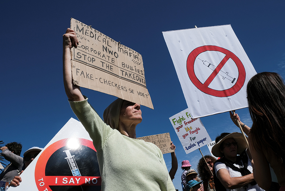 Anti-vaccine protesters hold placards during a march against COVID-19 vaccinations Sept. 18 in Cape Town, South Africa. (CNS/Reuters/Mike Hutchings)