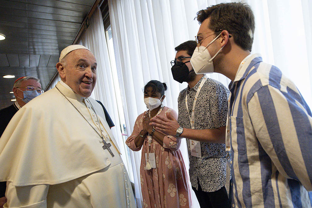 Pope Francis greets people during a meeting with representatives of bishops' conferences from around the world at the Vatican Oct. 9. The meeting came as the Vatican launched the process that will lead up to the assembly of the world Synod of Bishops.