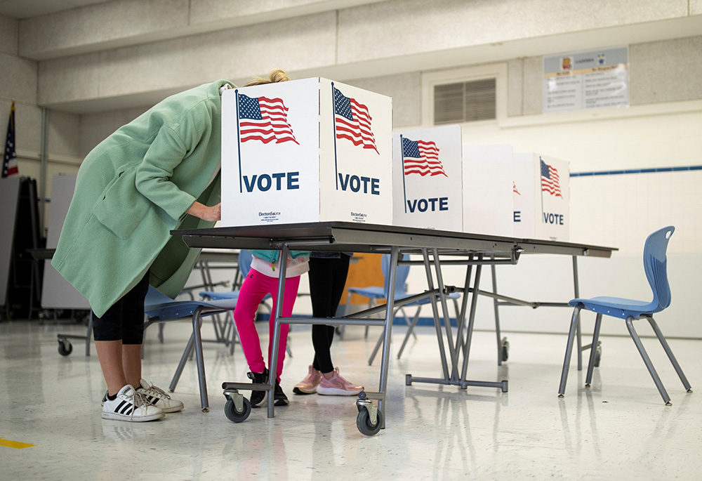 A mother in McLean, Virginia, casts her vote during the governor's race Nov. 2, 2021. (CNS/Reuters/Tom Brenner)