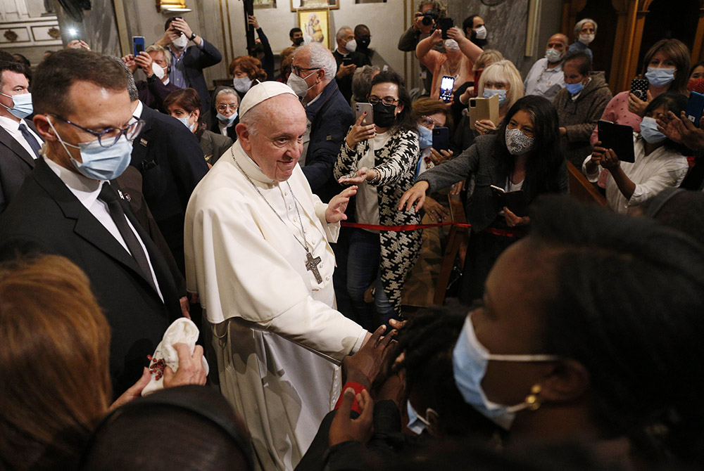 Pope Francis greets people as he leaves an ecumenical prayer with migrants in the Church of the Holy Cross Dec. 3 in Nicosia, Cyprus, Dec. 3. (CNS/Paul Haring)