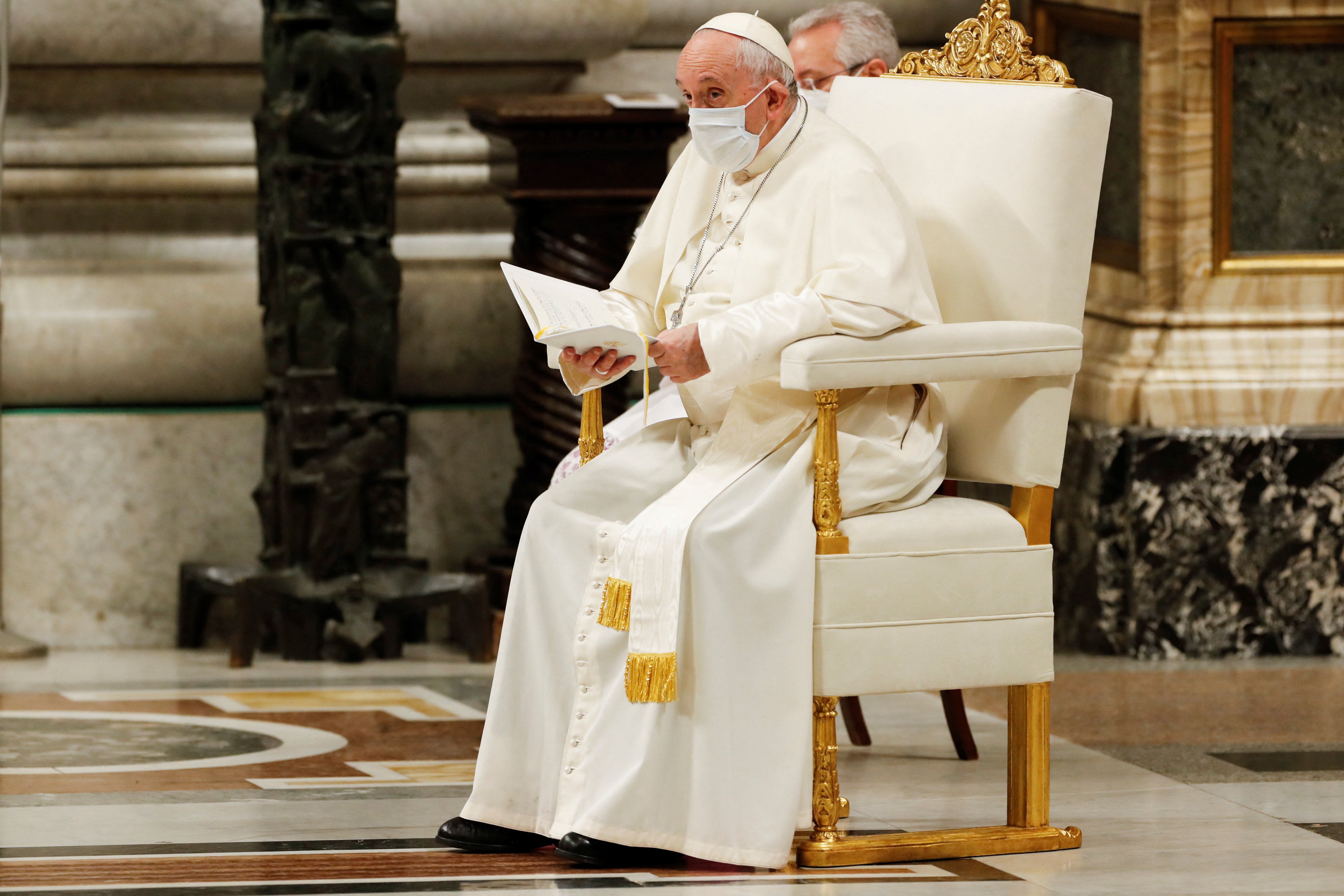 Pope Francis wears a mask for protection from COVID-19 as he participates in an evening prayer service in St. Peter's Basilica at the Vatican Dec. 31, 2021. (CNS photo/Remo Casilli, Reuters)