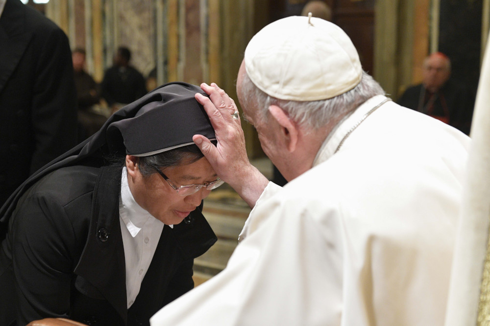 Pope Francis blesses a nun during an audience at the Vatican with students and staff of the Claretian Institute of the Theology of Consecrated Life in Rome, Nov. 7, 2022. 