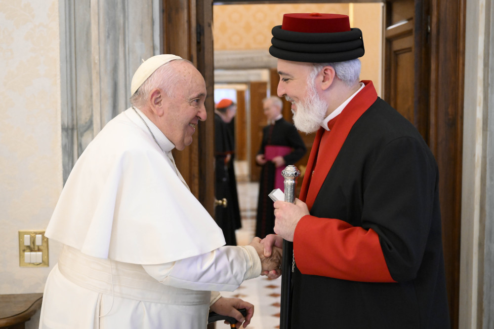 Pope Francis shakes hands with Catholicos Awa III, patriarch of the Assyrian Church of the East, at the end of a meeting Nov. 19, 2022, in the library of the Apostolic Palace at the Vatican. 