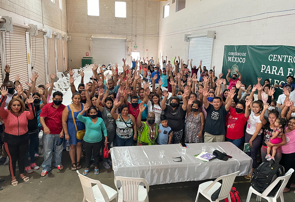 Fr. Stan Chu Ilo, center, wearing green, poses with people at a holding center for migrants in Ciudad Juarez, Mexico. Ilo and others interviewed the people at the center for the Vatican's "Doing Theology from the Existential Peripheries" project. (Courtesy of Stan Chu Ilo)