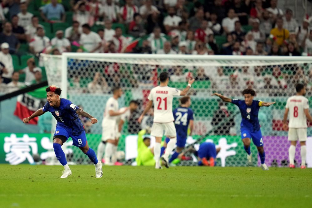 United States' Weston McKennie (8) celebrates after teammate Christian Pulisic scoring a goal during the World Cup group B soccer match between Iran and the United States at the Al Thumama Stadium in Doha, Qatar, Nov. 29. (AP/Ashley Landis)