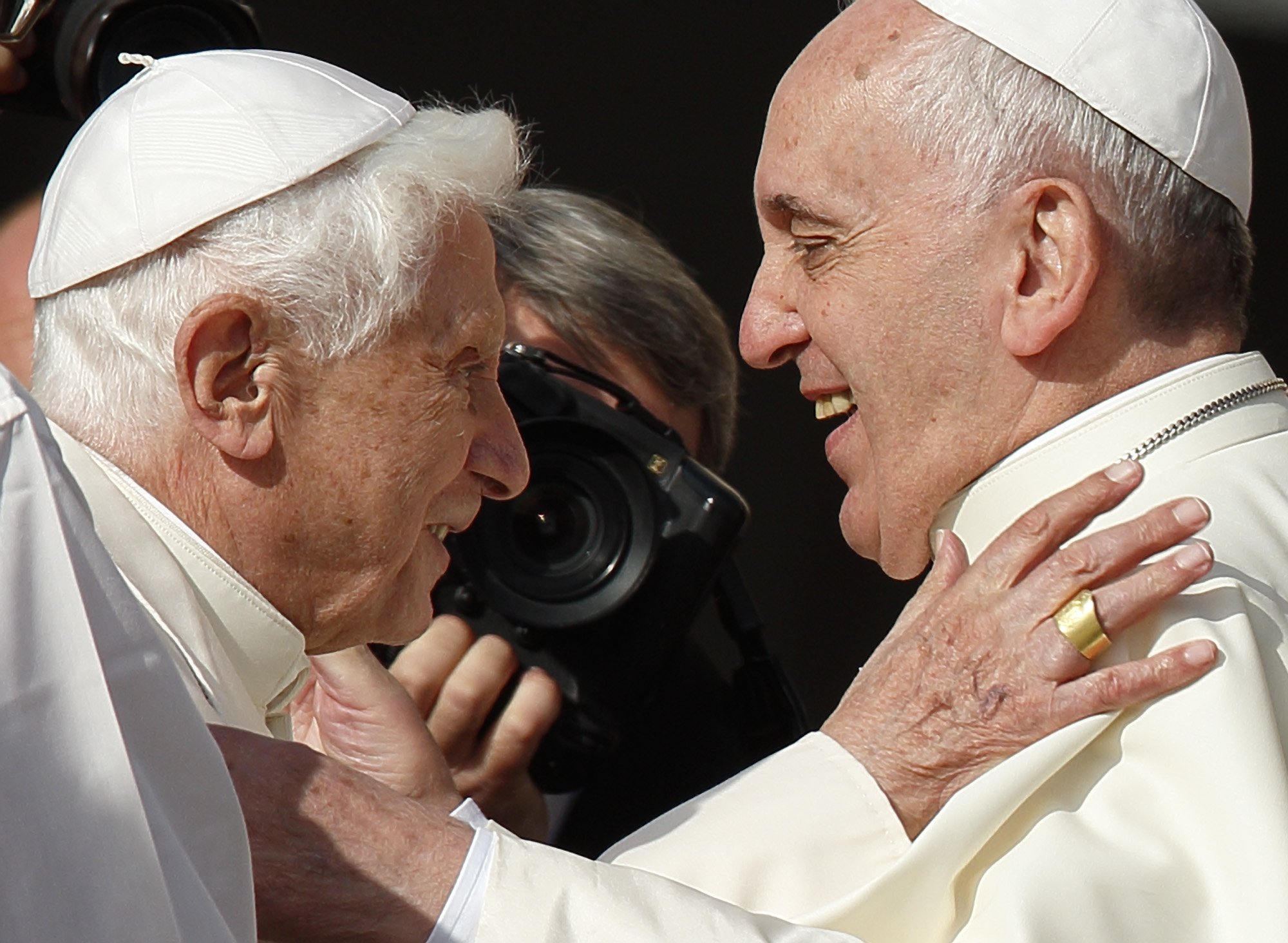 Retired Pope Benedict XVI greets Pope Francis during an event for the elderly in St. Peter's Square at the Vatican Sept. 28, 2014. Pope Benedict planned to live a "hidden life" in retirement, but to the delight and surprise of pilgrims and cardinals, he appeared at events with Pope Francis several times. (CNS photo/Paul Haring)