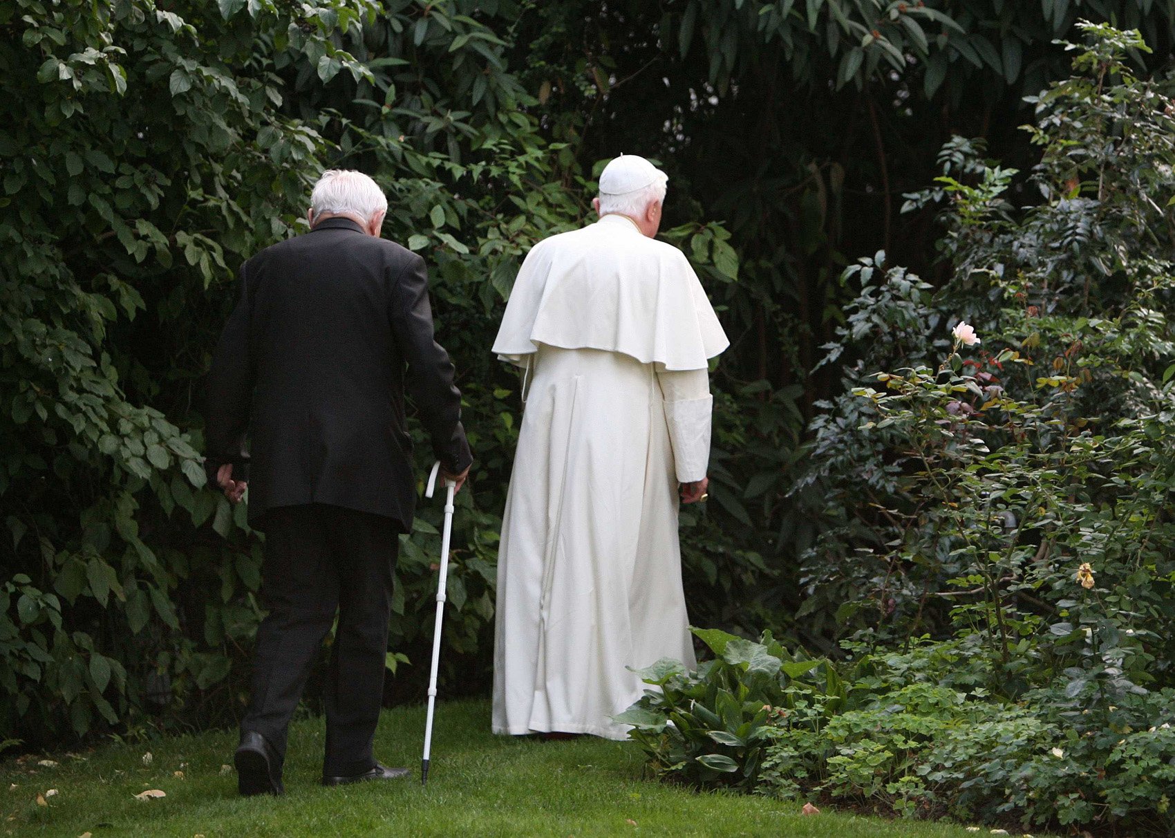 Pope Benedict XVI and his brother, Msgr. Georg Ratzinger, take a walk through the garden of a house the pope owns in Pentling, near Regensburg, Germany, Sept. 13, 2006. Pope Benedict died Dec. 31, 2022, at the age of 95 in his residence at the Vatican. 