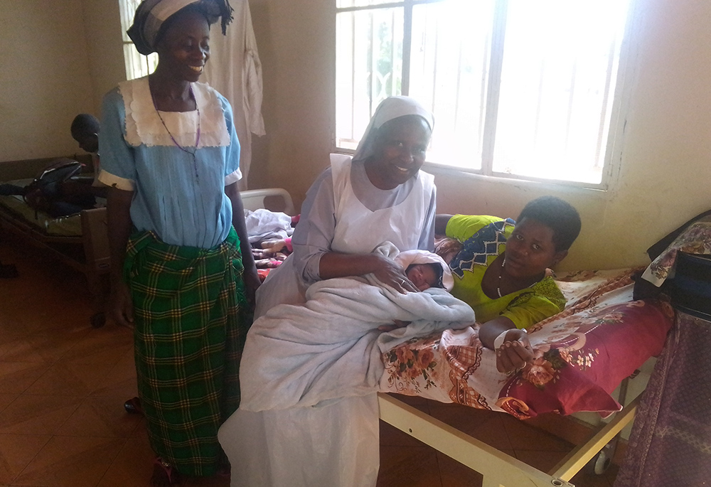 Sr. Jane Frances Kabagaaju is pictured with a patient after the successful delivery of a baby. Kabagaaju is the manager of the Nkuruba Health Centre in the rural Rwenzori region of Uganda, a mountainous region bordering the Democratic Republic of Congo. She was one of three Catholic sisters recognized with a Builders of Africa's Future award in 2022. (Courtesy of Sr. Jane Frances Kabagaaju)