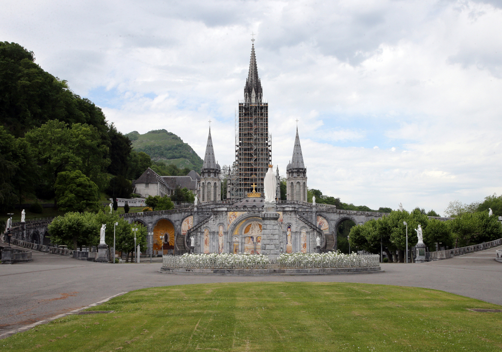 A gray Cathedral with scaffolding around one of its towers