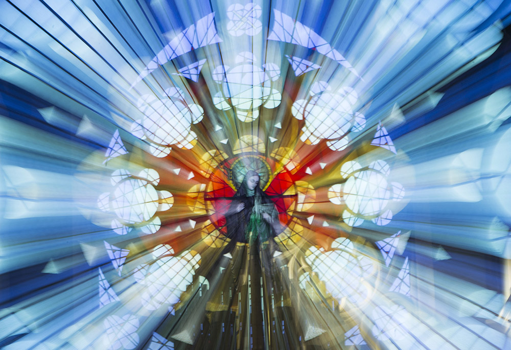 St. Brigid of Kildare is pictured in a stained-glass window in St. Brigid's Church in Crosshaven, a village in County Cork, Ireland, in this zoomed exposure taken Jan. 20. (CNS/Cillian Kelly)