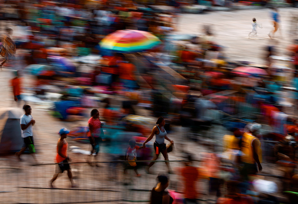 Migrants in Tapachula, Mexico, wait in a stadium Dec. 3, 2021, as they hope to receive help from the Mexican government to obtain humanitarian visas to transit Mexico. (CNS/Reuters/Jose Luis Gonzalez)