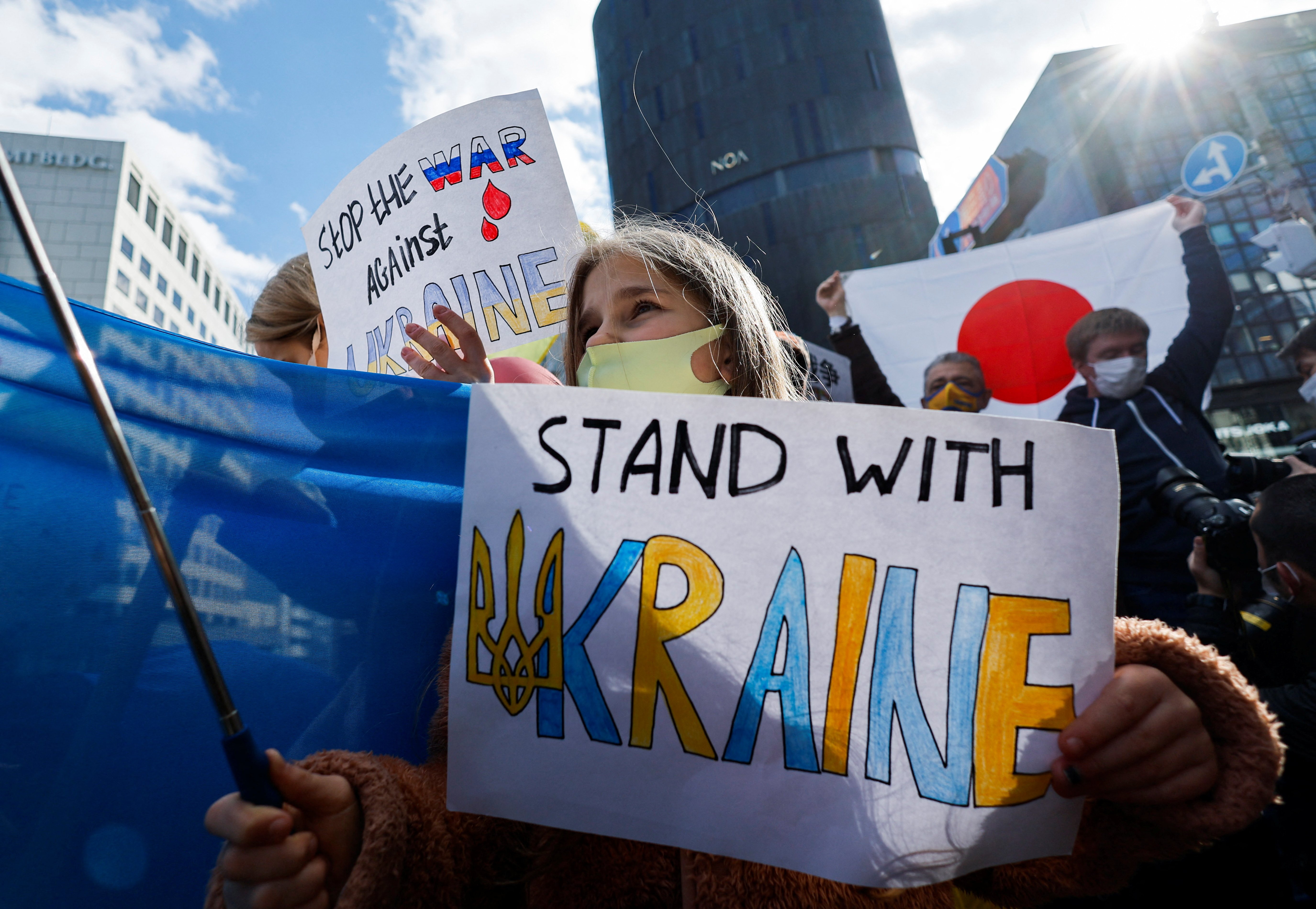 A Ukrainian residing in Japan shows a placard during a protest rally denouncing Russia over its actions in Ukraine, near the Russian Embassy in Tokyo Feb. 23, 2022. (CNS photo/Issei Kato, Reuters)