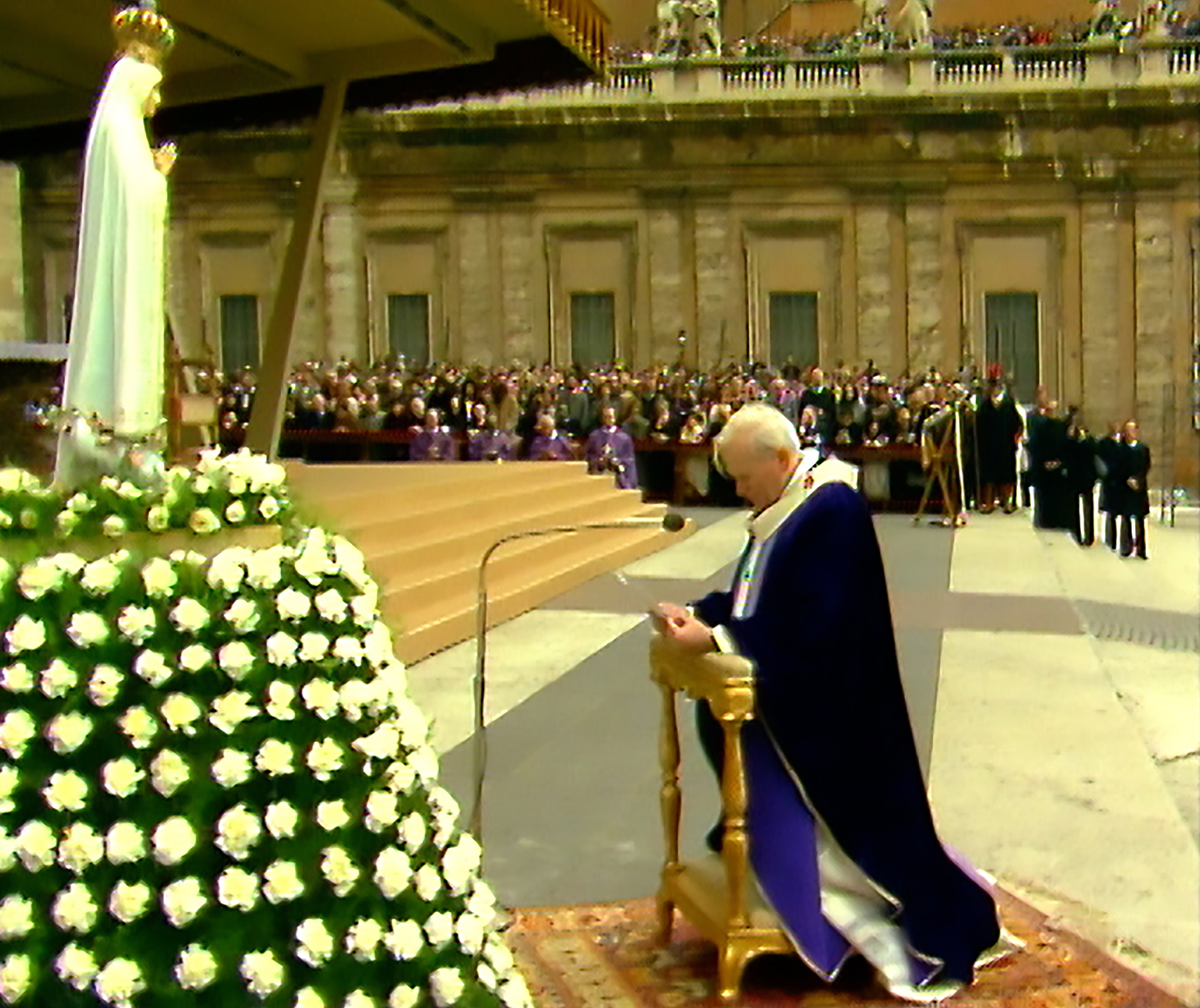 Pope John Paul II kneels in front of the statue of Our Lady of Fatima as he entrusts "all men and women and all peoples to the Immaculate Heart of Mary," in St. Peter's Square at the Vatican in this March 25, 1984, photo. (CNS photo/Vatican Media)