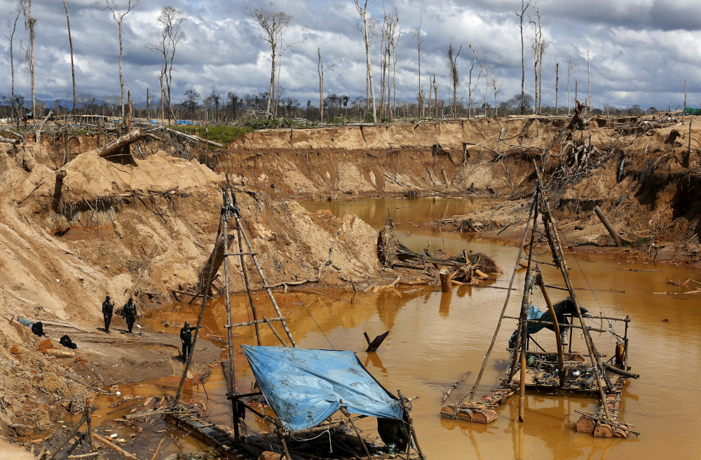 Peruvian police take part in an operation to destroy illegal wildcat gold mining camps in a zone known as Mega 14, in the southern Amazon region of Madre de Dios, Peru, Jan. 19, 2018. (CNS/Reuters/Janine Costa)