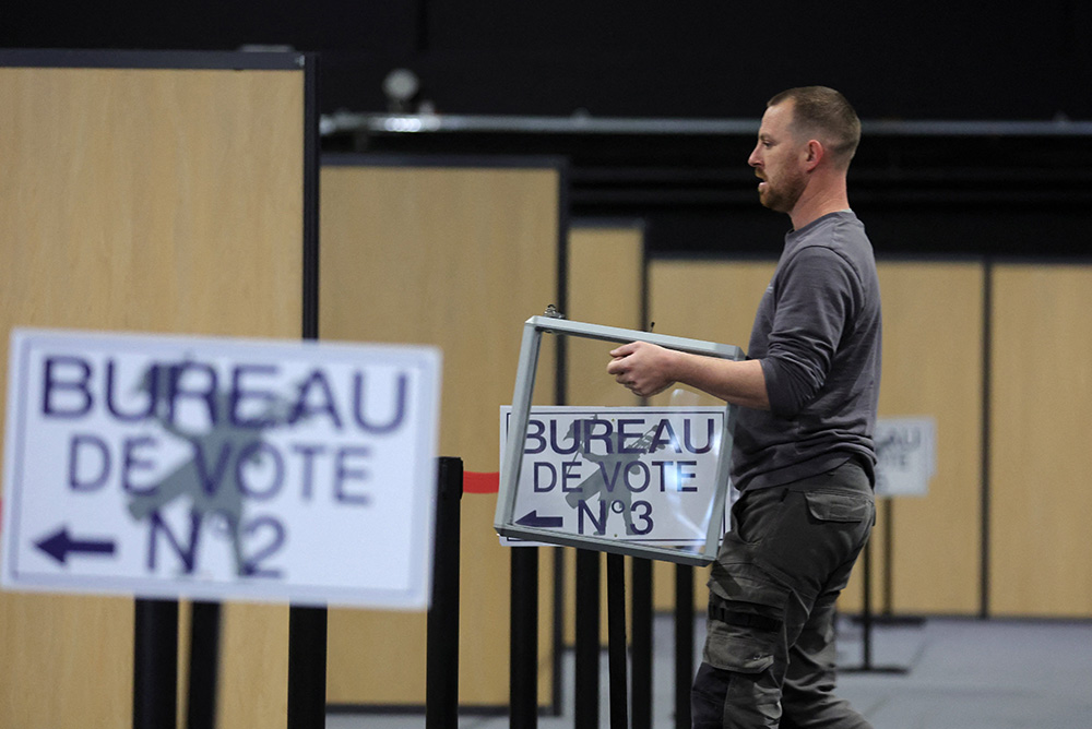 A worker carries a ballot box as he prepares the polling station in Le Touquet-Paris-Plage, France, April 6, for the April 10 presidential election. (CNS/Reuters/Pascal Rossignol)