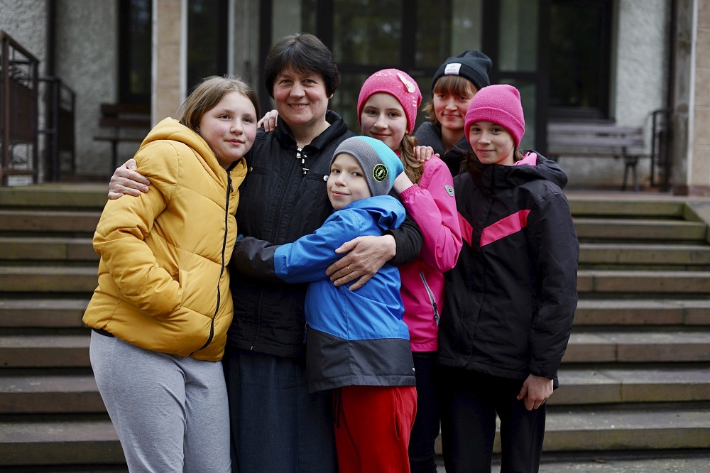 Sr. Antonina Sinicka, a member of the Congregation of Sisters of the Angels, poses with five of the children from a group home in Zhytomyr, Ukraine, at the congregation's motherhouse in Konstancin-Jeziorna, Poland, on April 20. (CNS/Adrian Kowalewski)