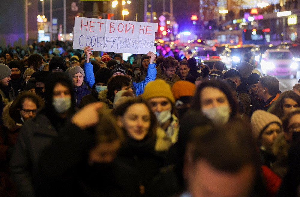 A person holds up a banner during an anti-war protest in Moscow Feb. 24, after Russia launched a massive military operation against Ukraine. The banner reads, "No war. Freedom for political prisoners."