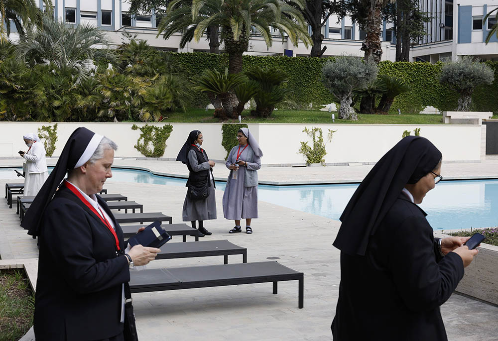 Nuns talk and use their phones during a break as superiors of women's religious orders meet for the plenary assembly of the International Union of Superior Generals in Rome May 3. (CNS/Paul Haring)