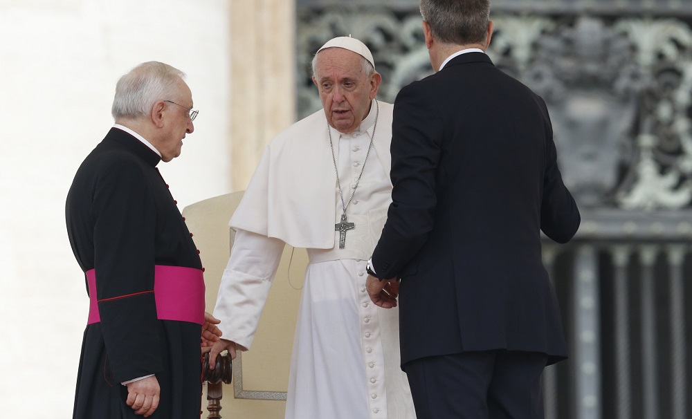 Pope Francis is assisted by his aide, Sandro Mariotti, right, and Msgr. Leonardo Sapienza, an official of the prefecture of the Papal Household, as he gets up from his chair during his general audience May 4 in St. Peter's Square at the Vatican. (CNS/Paul