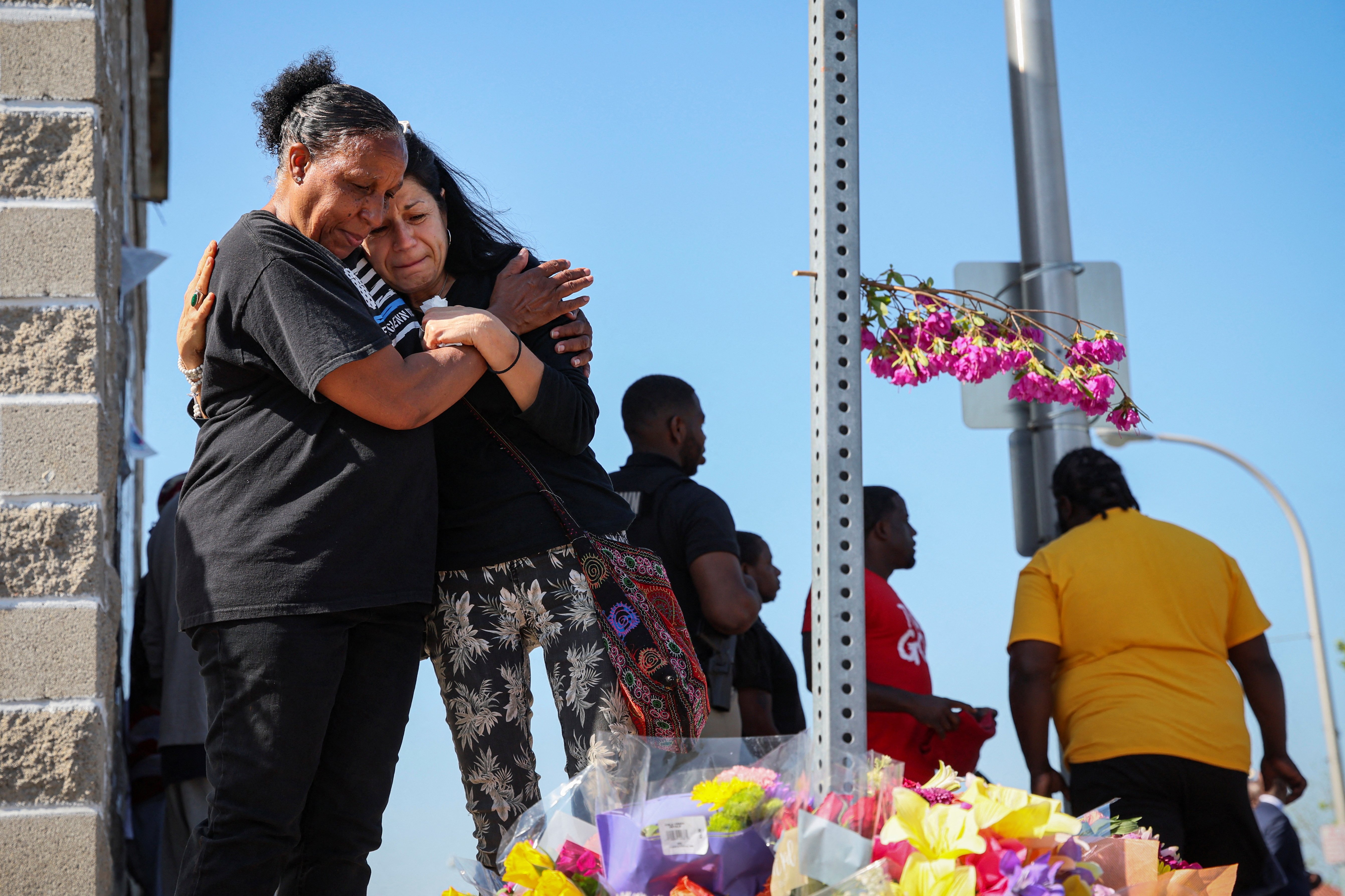 Mourners in Buffalo, N.Y., react May 15, 2022, while attending a vigil for victims of the shooting the day before at a TOPS supermarket. (CNS photo/Brendan McDermid, Reuters)