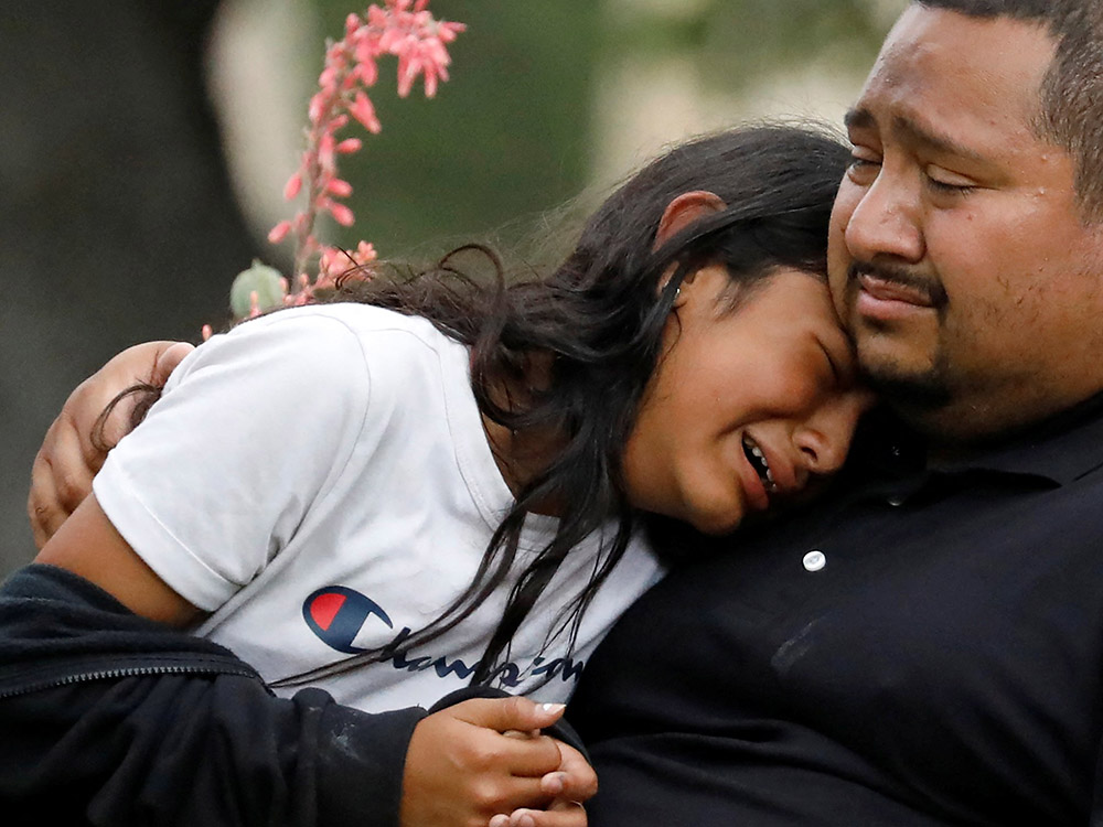 People react outside the SSGT Willie de Leon Civic Center, where students had been transported from Robb Elementary School after a shooting, in Uvalde, Texas, May 24. (CNS/Reuters/Marco Bello)