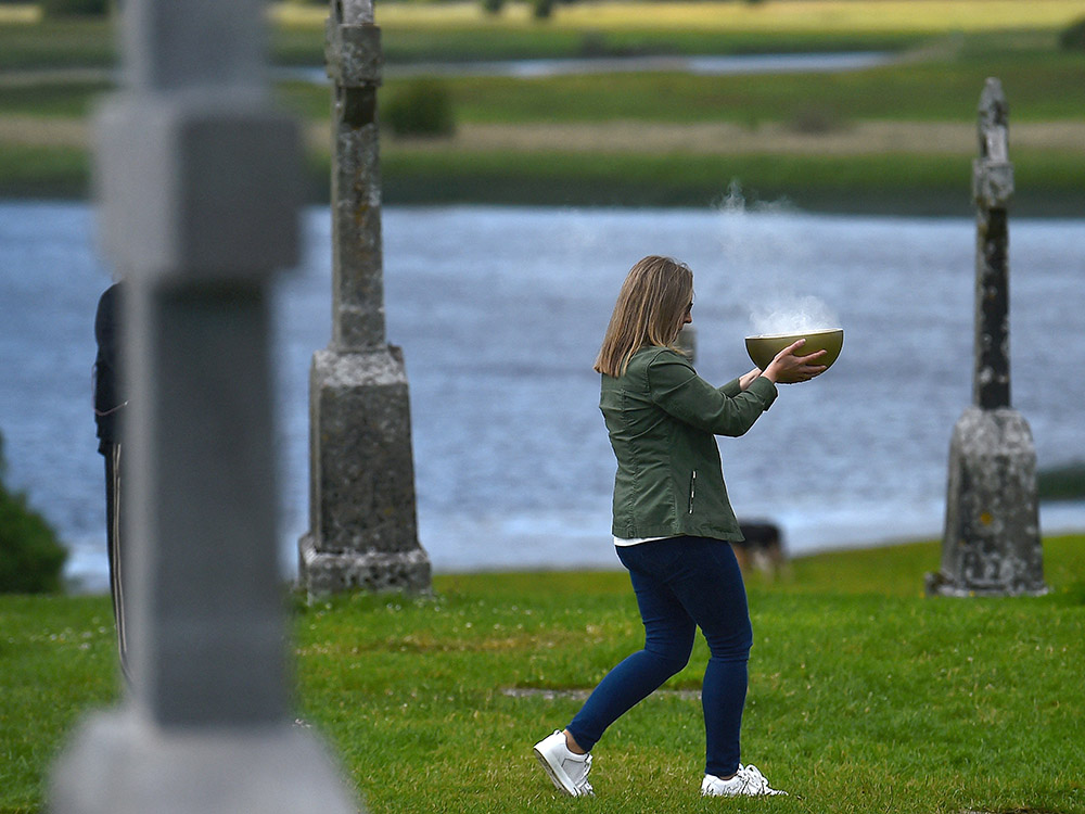 A delegate carries a bowl of incense during a prayer walk at a pre-synodal assembly in the sixth-century monastic site of Clonmacnoise in Ireland June 18. (CNS/Reuters/Clodagh Kilcoyne)