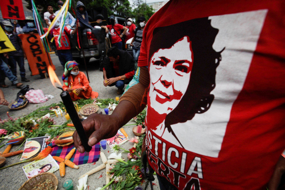 A demonstrator holds a candle as he protests outside the Supreme Court in Tegucigalpa, Honduras, June 20, 2022, during sentencing for Roberto David Castillo, former business executive and army intelligence officer. (CNS/Reuters/Fredy Rodriguez)