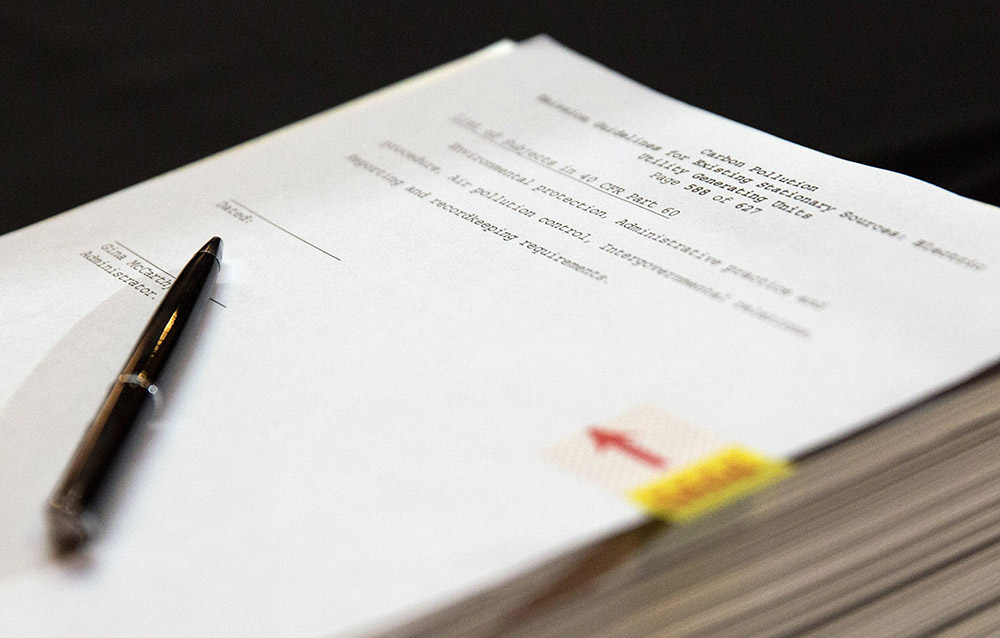 The proposal under the Clean Air Act to cut carbon pollution from existing power plants is seen before a news conference in Washington June 2, 2014. (CNS/Reuters/Joshua Roberts)